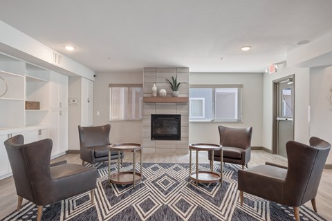 a living room with couches and chairs and a fireplace